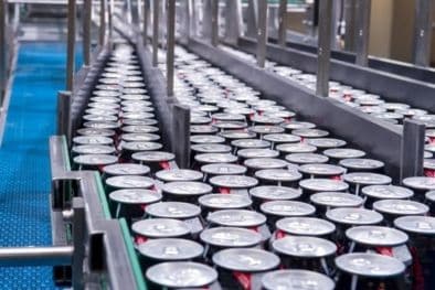 Aluminium cans moving along a production conveyor